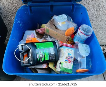 San Jose, CA - June 1, 2022: Open Lid On A Blue Recycling Container Full Of Plastics And Paper Products.