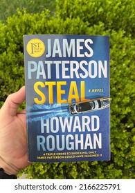 San Jose, CA - May 26, 2022: Hand Holding A Book By James Patterson, A Novel Called Steal. 