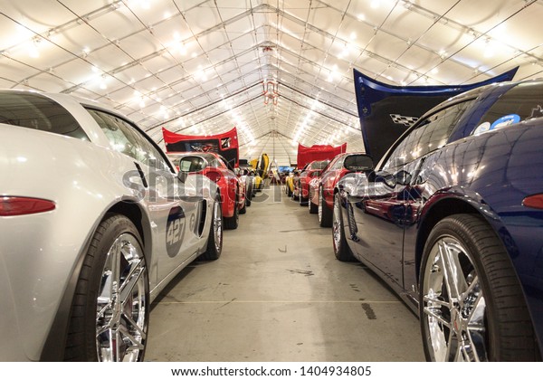 San\
Jose, Ca / USA - 01/07/2012: A collection of Corvettes sit in a\
warehouse for spectators to enjoy at the car\
show.