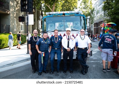SAN JOSE, CA, U.S.A. - AUG. 29, 2021:San Jose Fire Chief Robert Sapien Jr. Poses With Other Firefighters During Silicon Valley Pride. In Front Of A Fire Engine.