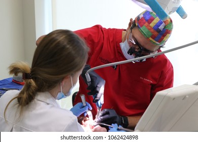 San Jose / Costa Rica; July 1, 2016; Dentist Mario Garita (R) Works On A Dental Patient With An Assistant In Costa Rica. His Business Is Called The Dental Experience And Practices Holistic Dentistry.