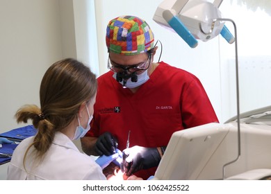 San Jose / Costa Rica; July 1, 2016; Dentist Mario Garita (R) Works On A Dental Patient With An Assistant In Costa Rica. His Business Is Called The Dental Experience And Practices Holistic Dentistry.