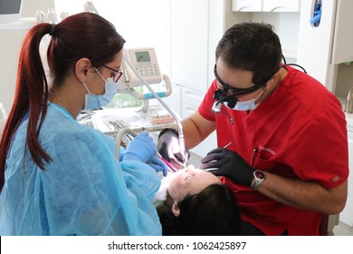 San Jose / Costa Rica; July 1, 2016; Dentist Mario Garita (R) Works On A Dental Patient With An Assistant In Costa Rica. His Business Is Called The Dental Experience And Practices Holistic Dentistry.