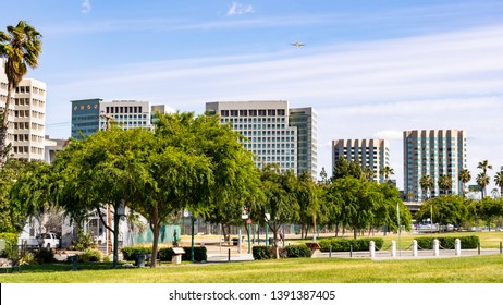 San Jose's downtown skyline as seen from the shoreline of Guadalupe River Park on a sunny spring day; Silicon Valley, California