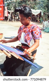 SAN JUAN CHAMULA, MEXICO - AUGUST 14, 1998:Indigenous Tzotzil Maya Woman Weaving A Traditional Huipil At The Loom.