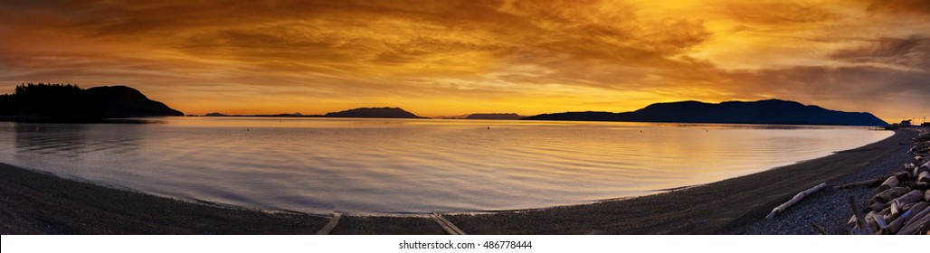 San Juan Islands Sunset. A Beautiful Panoramic Winter Sunset From Legoe Bay On Lummi Island Looking West Towards Orcas Island In The San Juan Archipelago In Western Washington State.