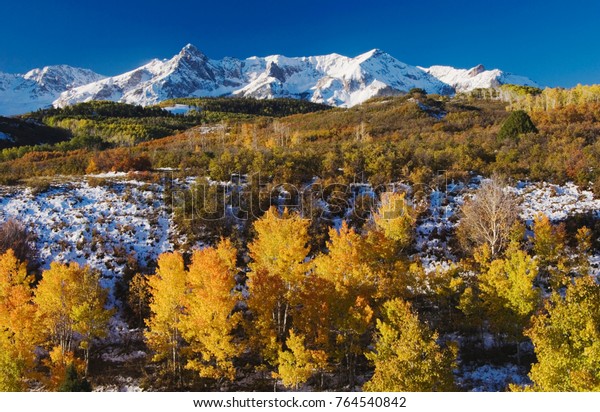 San Juan Mountains and Aspen trees in fallcolor\
at sunrise, Dallas Divide, Ouray, Rocky Mountains, Colorado, USA,\
September