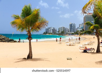 SAN JUAN, PUERTO RICO - JUNE 11, 2014: People Relaxing At Popular Touristic Condado Beach In San Juan, Puerto Rico, On June 11, 2014