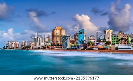 San Juan, Puerto Rico resort skyline on Condado Beach on dusk.