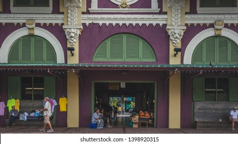 San Juan, Puerto Rico, USA - Jan. 2, 2018: Vendors of the Santurce Market sitting and taking a break at the entrance to the market