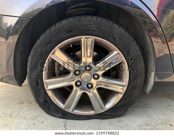 San Leandro, CA - Nov 14,\
2018: Flat GoodYear tire totally ripped up from driving after tire\
blew.