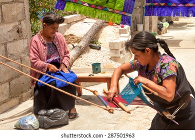 San Lorenzo Zinacantan, Mexico - May 10, 2014: Indigenous Tzotzil Women Weaving A Traditional Huipil At The Loom. 