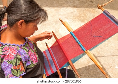 San Lorenzo Zinacantan, Mexico - May 10, 2014: Indigenous Tzotzil woman weaving a traditional Huipil at the loom. 