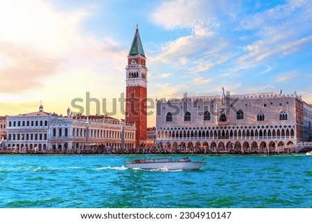San Marco and Doge's Palace of Venice with many tourists under a sunset sky, Italy