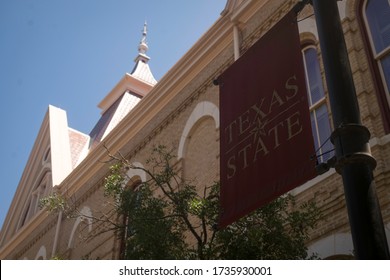San Marcos, Texas - May 19 2020: Texas State University Banner And Old Main Building 
