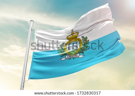 San Marino national flag cloth fabric waving on the sky  - Image