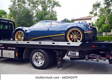 SAN MARINO/CALIFORNIA - JUNE 11, 2017: High performance Pagani Huayra an Italian mid-engined sports car loaded on a flatbed tow truck and parked on a residential street in San Marino, California USA