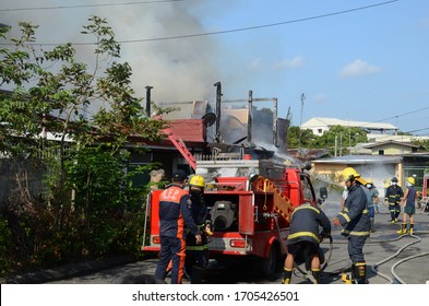 San Pablo City, Laguna, Philippines - April 15, 2020: Firemen and volunteers working assembling fire hoses in fire truck in the area of a burning house