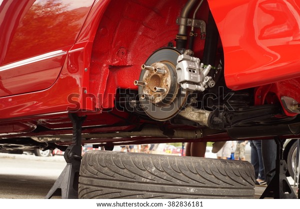 San Pablo City,\
Laguna, Philippines - September 12, 2015: Wheel of a red car tire\
removed showing disk brake