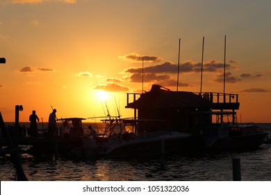 San Pedro, Ambergris Caye / Belize - Mar 16 2018: Fishermen Taking Off The Pier Of The Dive Bar At Sunrise