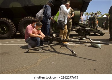 San Pedro, California - 
May 28, 2022:
A Father Teaches His Son How To Fire A Machine Gun Four Days After The School Mass Shooting In Uvalde, Texas.