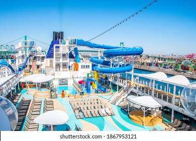 San Pedro, California - October 11 2019: Empty Sun Deck On Norwegian (NCL) Joy Cruise Ship With Waterslides, Pools, Hot Tubs And Lounge Chairs For Sunbathing. Sailing In San Pedro, Port Of Los Angeles