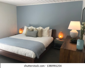 San Rafael, CA/USA - April 21, 2019: A Cozy Well Lit Bedroom In Vibrant And Inviting Colors With A Neatly Made Bed