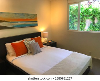 San Rafael, CA/USA - April 21, 2019: A Cozy Well Lit Bedroom In Vibrant And Inviting Colors With A Neatly Made Bed