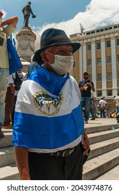 San Salvador, El Salvador - September 15th, 2021: A Civil War Veteran Protests Against The Politics Of Current President Nayib Bukele By Wrapping The National Flag Around Him.