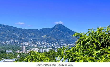 San Salvador, El Salvador, with the San Salvador volcano in the background. A vibrant metropolis surrounded by mountains, with a rich history and culture.