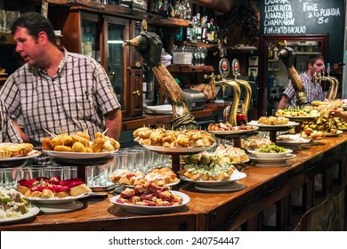 SAN SEBASTIAN, SPAIN - SEPTEMBER 28, 2014: View of a bar with traditional pinchos in San Sebastian, Basque Country, Spain. Pinchos (Pintxos) are traditional appetizer in Basque country.