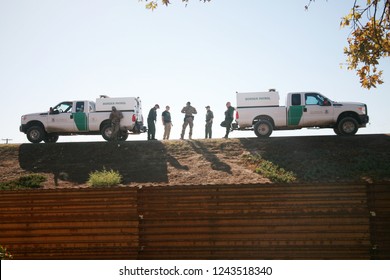 San Yasidro, California - 11/26/2018: Border patrol agents discuss their next moves and survey the landscape at the US Mexico Border. Government and Border agents are all on High Alert.