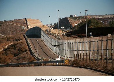 San Ysidro, California - 11/26/2018: The secured border fence and road for United States border patrol vehicles on the US - Mexico international border in California
 - Shutterstock ID 1242713470