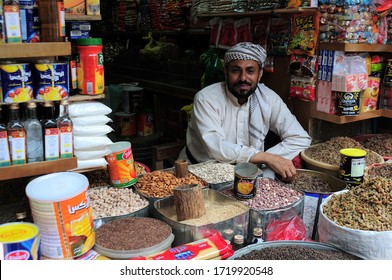 
Sana'a, Yemen - July 29, 2010: A view from the historic Sana'a market. A grocery store in the bazaar. Businessman in traditional suit. Nuts specific to Yemen.