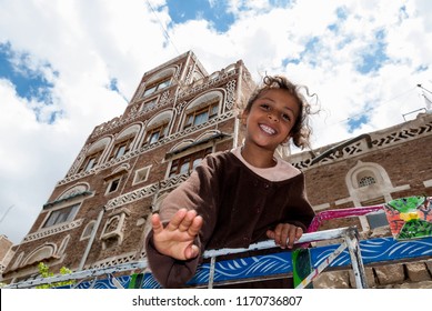 Sanaa, Yemen - May 4, 2007: A girl on a vehicle smiles at the camera. Although infant mortality is high, children in Yemen are culturally, socially and religiously valued.