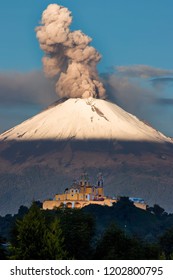 The Sanctuary Of Nuestra Señora De Los Remedios In The Magic Town Of San Andres Cholula (Puebla) With The Popocatépetl Volcano Throwing Ash In The Background.