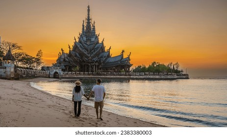 Sanctuary of Truth, Pattaya, Thailand, wooden temple by the ocean during sunset on the beach of Pattaya Chonburi Thailand, skyline of Pattaya at sunset, a couple on vacation in Pattaya