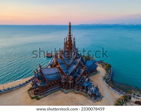 Sanctuary of Truth, Pattaya, Thailand, wooden temple by the ocean during sunset on the beach of Pattaya. Temple of Truth in Thailand