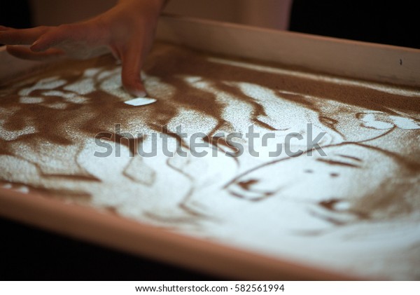 Sand animation. Hands\
girls draw sand\
