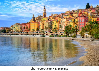 Sand beach beneath the colorful old town Menton on french Riviera, France - Shutterstock ID 371656303