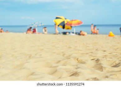 sand beach closeup with umbrellas near sea. soft focus on bottom of the picture - Powered by Shutterstock