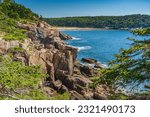 Sand Beach in the distance of rocky coastline at Arcadia National Park in Maine