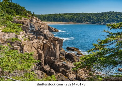 Sand Beach in the distance of rocky coastline at Arcadia National Park in Maine