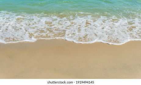 Sand Beach Seaside With White Foamy Blue Wave From The Sea