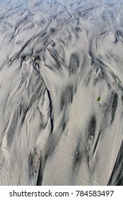 Sand Being Washed Away By Waves