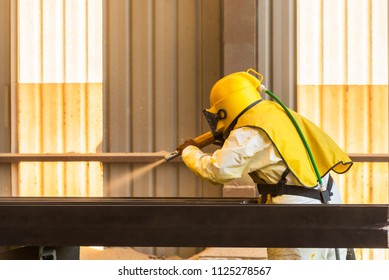 Sand blasting process, Industial worker using sand blasting process preparation cleaning surface on steel before painting in factory workshop. - Shutterstock ID 1125278567