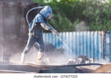 Sand Blasting Process, Industial Worker Using Sand Blasting Process Preparation Cleaning Surface On Steel Before Painting In Factory Workshop.