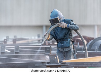 Sand blasting process, Industial worker using sand blasting process preparation cleaning surface on steel before painting in factory workshop. - Shutterstock ID 1419016772