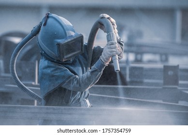 Sand blasting process, Industial worker using sand blasting process preparation cleaning surface on steel before painting in factory workshop. - Shutterstock ID 1757354759