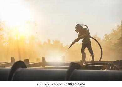 Sand Blasting Process, Industial Worker Using Sand Blasting Process Preparation Cleaning Surface On Steel Before Painting In Factory Workshop.